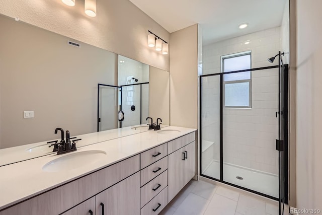 bathroom featuring tile patterned flooring, vanity, and walk in shower