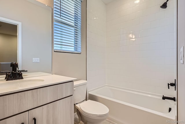 full bathroom featuring vanity, toilet, and tiled shower / bath