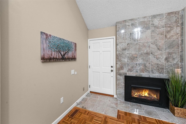11704 Elk Head Range Rd, Littleton, CO 80127 - entryway featuring a textured ceiling, lofted ceiling, and a fireplace