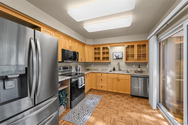 11704 Elk Head Range Rd, Littleton, CO 80127 - kitchen with appliances with stainless steel finishes, light countertops, light brown cabinets, and glass insert cabinets
