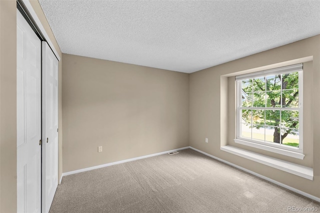 11704 Elk Head Range Rd, Littleton, CO 80127 - unfurnished bedroom with carpet, a textured ceiling, and a closet