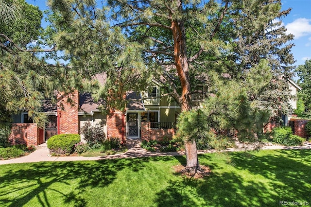11704 Elk Head Range Rd, Littleton, CO 80127 - view of property hidden behind natural elements featuring brick siding and a front lawn