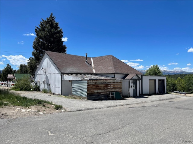 view of home's exterior with roof with shingles