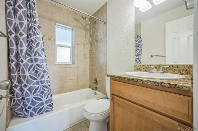 bathroom featuring a textured wall, shower / bath combo, toilet, vanity, and tile patterned floors
