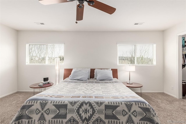 bedroom featuring a walk in closet, visible vents, and carpet floors
