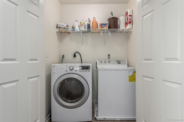 washroom with separate washer and dryer and laundry area