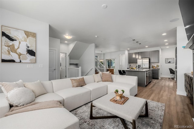 13736 Umatilla Ln, Broomfield, CO 80023 - living room featuring recessed lighting, light wood-type flooring, and stairway