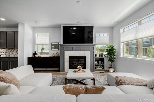 13736 Umatilla Ln, Broomfield, CO 80023 - living room with light wood-type flooring, recessed lighting, and a fireplace