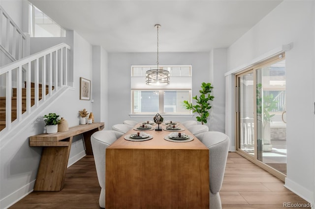 13736 Umatilla Ln, Broomfield, CO 80023 - dining room with a chandelier, healthy amount of natural light, and light wood finished floors