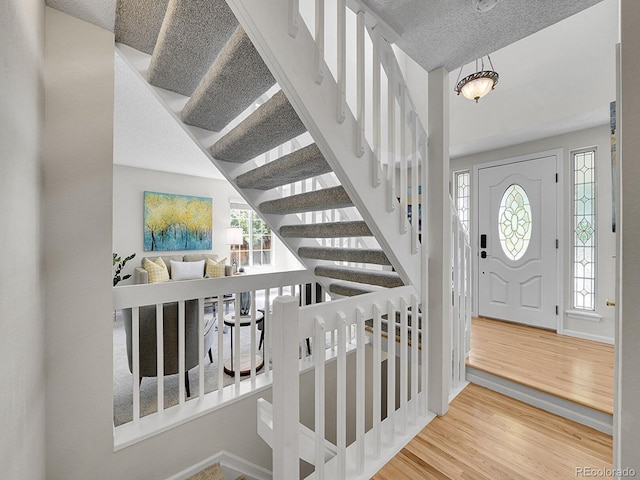 3661 Seramonte Dr, Highlands Ranch, CO 80129 - foyer with wood finished floors, stairway, and a textured ceiling