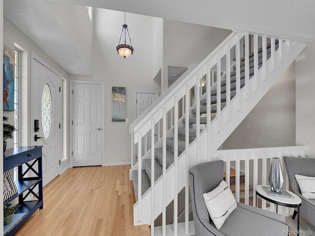 3661 Seramonte Dr, Highlands Ranch, CO 80129 - foyer with stairway and light wood-type flooring