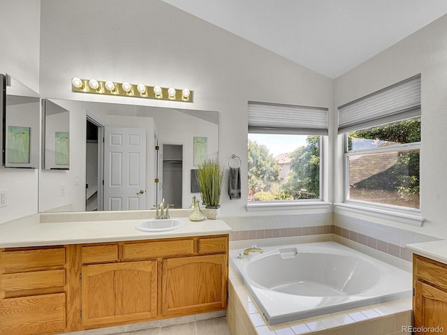 3661 Seramonte Dr, Highlands Ranch, CO 80129 - full bath with vanity, vaulted ceiling, and a garden tub