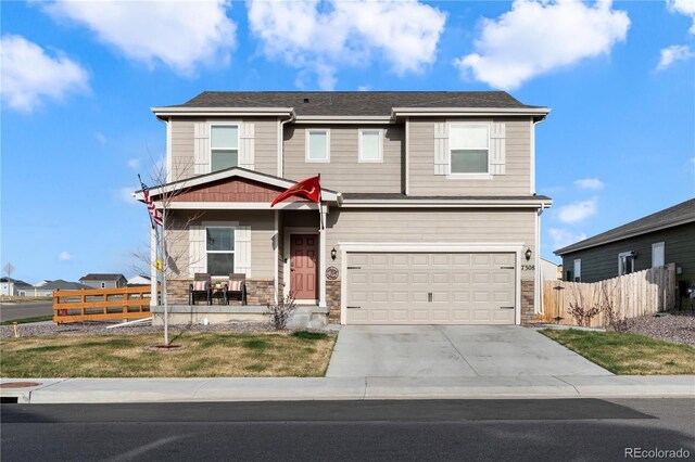 view of front of home featuring a front yard and a garage