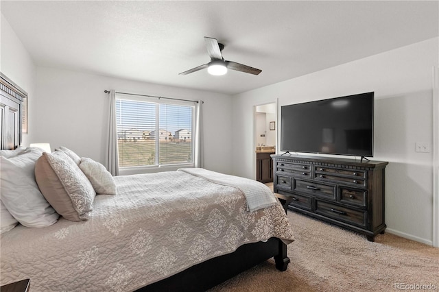 carpeted bedroom featuring ensuite bathroom and ceiling fan