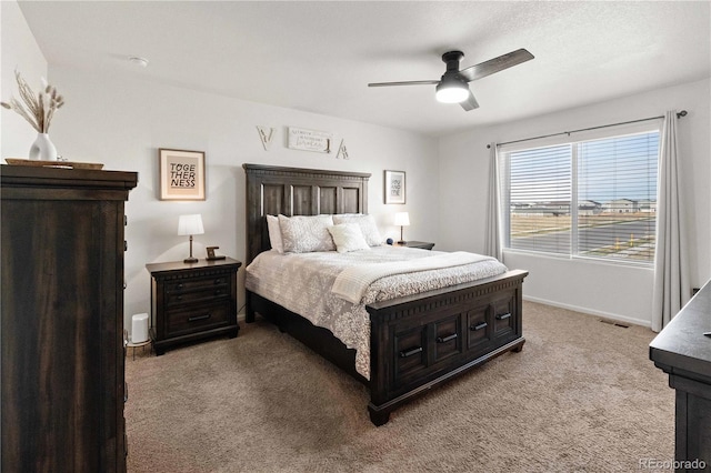 bedroom featuring light colored carpet and ceiling fan