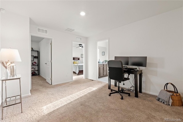 office area featuring light colored carpet and ceiling fan