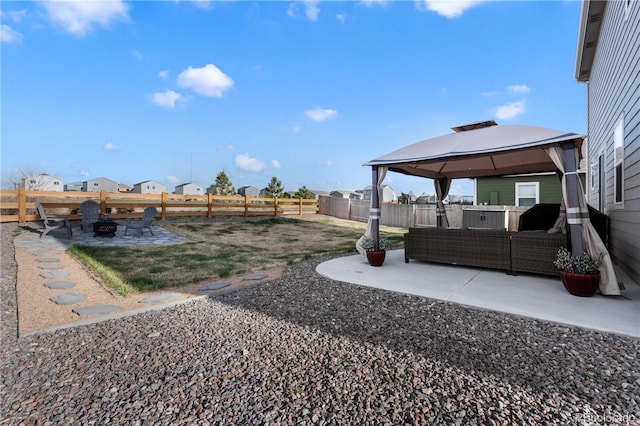 view of yard featuring a gazebo, a patio, and an outdoor living space with a fire pit