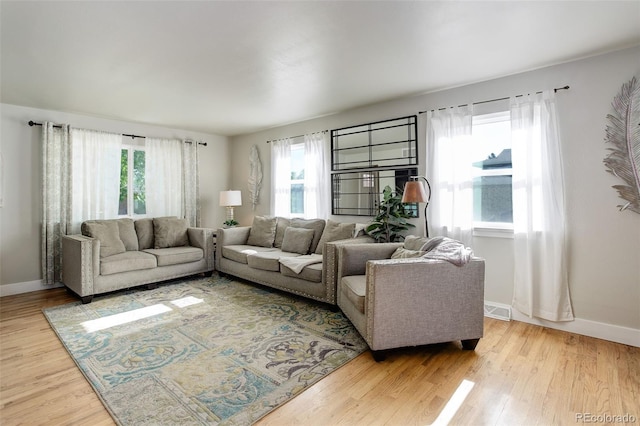 5332 W Roxbury Pl, Littleton, CO 80128 - living room featuring plenty of natural light, wood finished floors, and baseboards