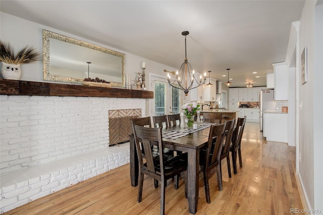5332 W Roxbury Pl, Littleton, CO 80128 - dining area featuring light wood-type flooring and a chandelier