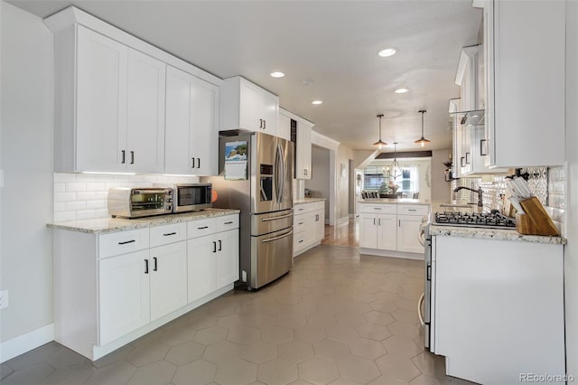 5332 W Roxbury Pl, Littleton, CO 80128 - kitchen featuring appliances with stainless steel finishes, recessed lighting, backsplash, white cabinets, and light stone countertops