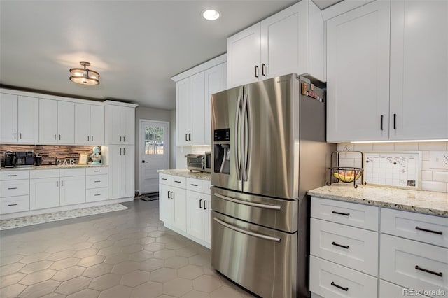 5332 W Roxbury Pl, Littleton, CO 80128 - kitchen featuring stainless steel fridge, tasteful backsplash, white cabinetry, tile patterned flooring, and recessed lighting