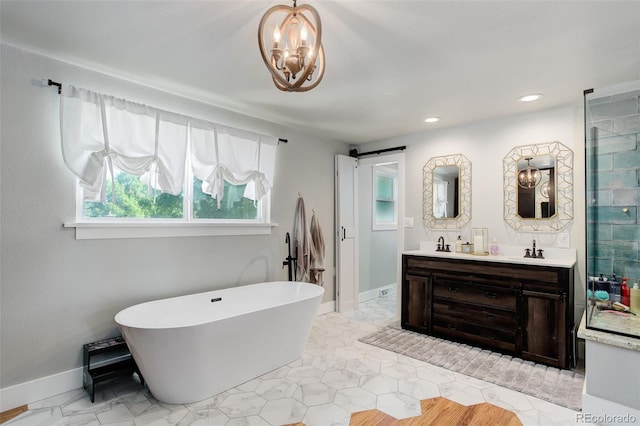 5332 W Roxbury Pl, Littleton, CO 80128 - bathroom featuring double vanity, a freestanding bath, a chandelier, recessed lighting, and baseboards