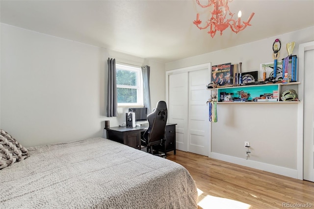 5332 W Roxbury Pl, Littleton, CO 80128 - bedroom featuring wood finished floors, a chandelier, baseboards, and a closet