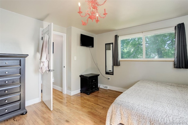 5332 W Roxbury Pl, Littleton, CO 80128 - bedroom with light wood-style floors, a chandelier, and baseboards