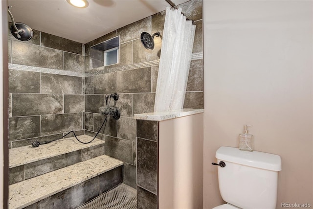5332 W Roxbury Pl, Littleton, CO 80128 - bathroom featuring tiled shower and toilet