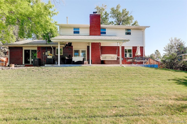 5332 W Roxbury Pl, Littleton, CO 80128 - rear view of property featuring brick siding, a chimney, a patio, and a yard
