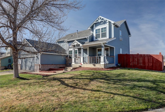 view of front of home featuring a front lawn, a porch, and a garage