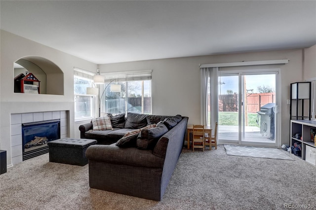 living room with carpet flooring and a fireplace