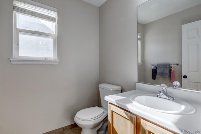 bathroom featuring tile patterned floors, vanity, and toilet