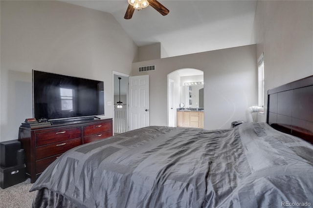 carpeted bedroom featuring ensuite bath, ceiling fan, and lofted ceiling