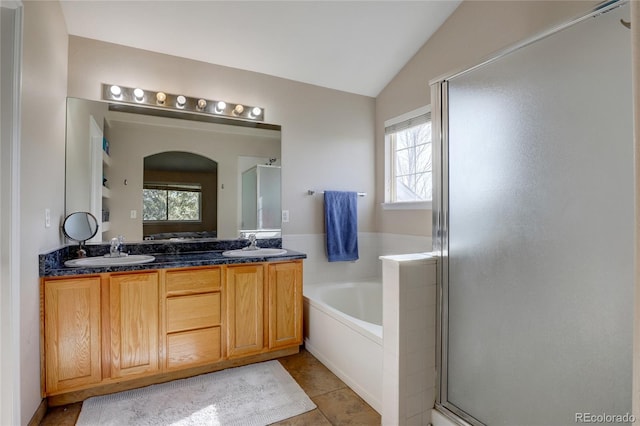 bathroom featuring tile patterned flooring, a healthy amount of sunlight, shower with separate bathtub, and lofted ceiling