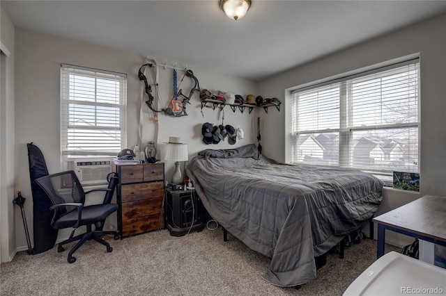 bedroom featuring cooling unit, light colored carpet, and multiple windows