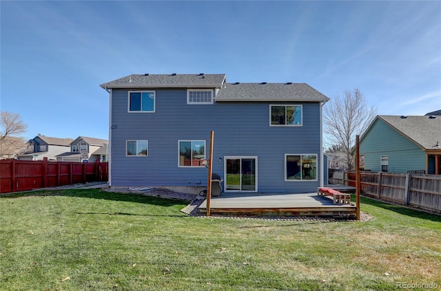 rear view of property featuring a lawn and a wooden deck