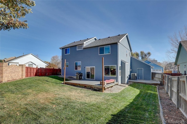 back of house with a yard, cooling unit, and a wooden deck