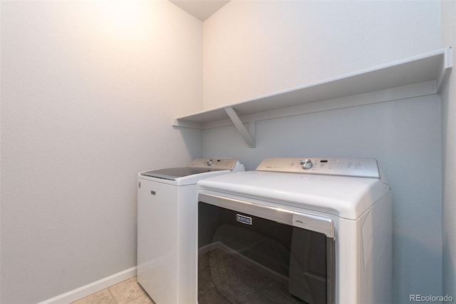 15443 W 65th Ave Unit B, Arvada, CO 80007 - washroom featuring separate washer and dryer and light tile patterned floors