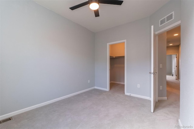 15443 W 65th Ave Unit B, Arvada, CO 80007 - unfurnished bedroom with light colored carpet, a spacious closet, a closet, and a ceiling fan
