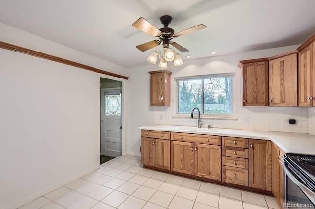 5370 S Sherman St, Littleton, CO 80121 - kitchen with a sink, brown cabinetry, electric stove, backsplash, and light countertops