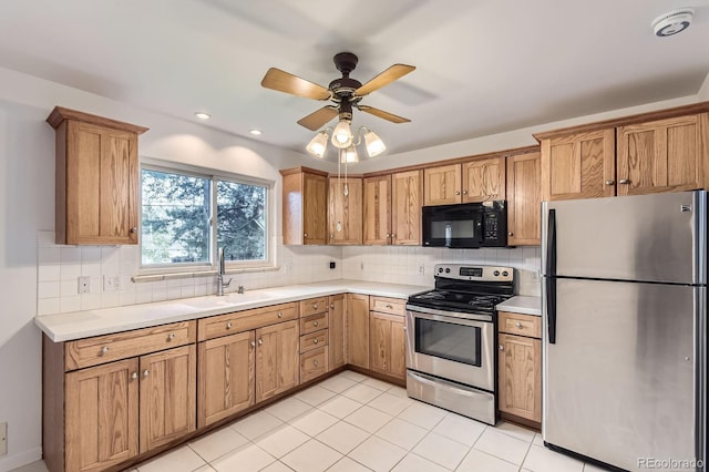 5370 S Sherman St, Littleton, CO 80121 - kitchen with appliances with stainless steel finishes, a sink, light countertops, and tasteful backsplash