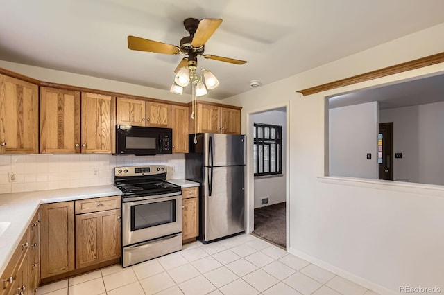 5370 S Sherman St, Littleton, CO 80121 - kitchen featuring stainless steel appliances, brown cabinets, backsplash, light countertops, and a ceiling fan