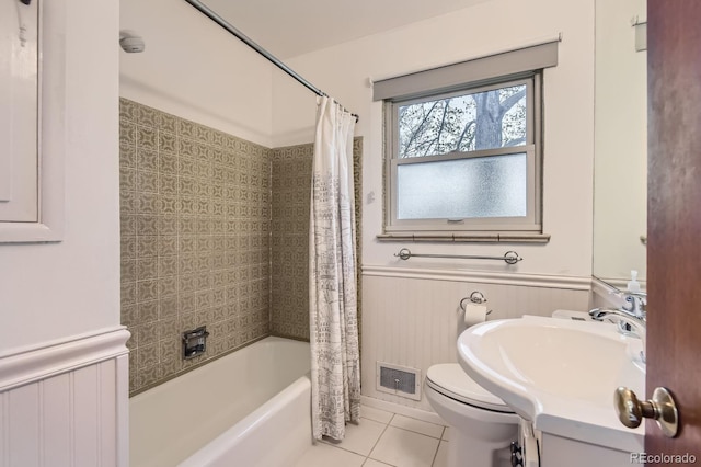 5370 S Sherman St, Littleton, CO 80121 - bathroom featuring tile patterned flooring, wainscoting, toilet, shower / tub combo with curtain, and a sink