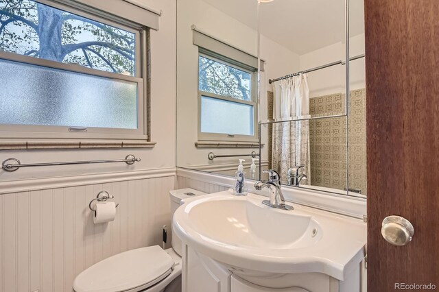 5370 S Sherman St, Littleton, CO 80121 - bathroom featuring toilet, wainscoting, vanity, and a shower with shower curtain