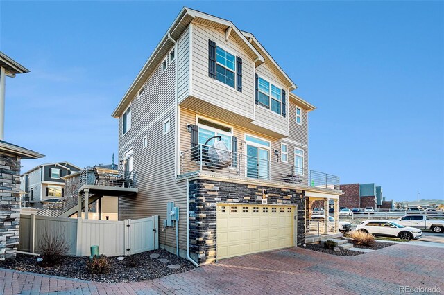 view of front of home featuring a garage and a balcony