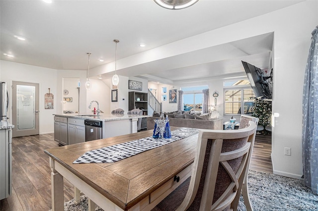 dining room featuring recessed lighting, wood finished floors, and baseboards