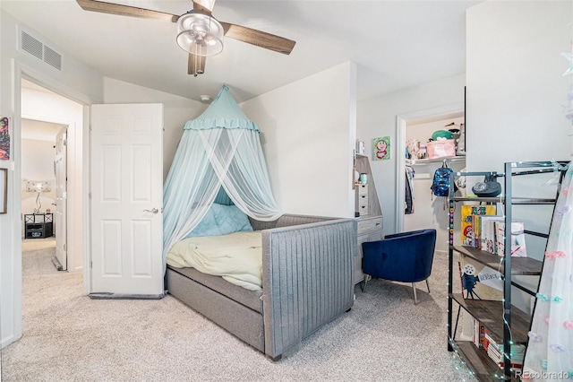 bedroom with visible vents, carpet flooring, and a ceiling fan