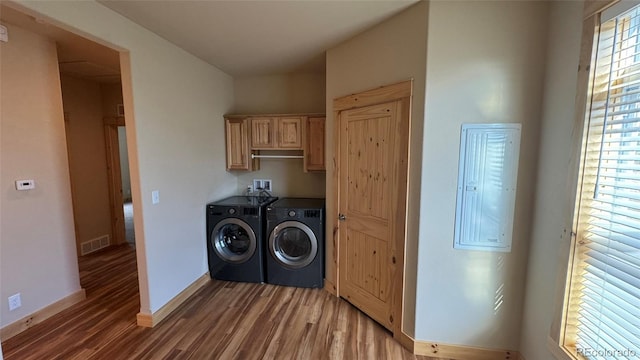 laundry area with cabinets, dark hardwood / wood-style flooring, and washer and clothes dryer