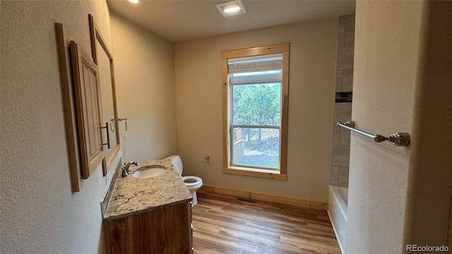 bathroom featuring vanity, hardwood / wood-style floors, and toilet